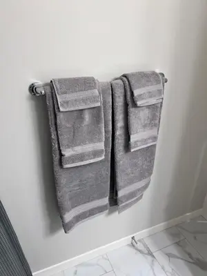 two towels hanging on a wall in a bathroom at The Lakefront - A new 2-bedroom in Mahogany Calgary in Calgary