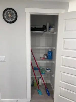 a closet with two mop in a room at The Lakefront - A new 2-bedroom in Mahogany Calgary in Calgary