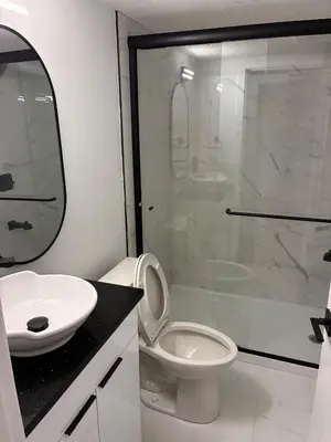 a bathroom with a shower and a toilet and a sink at Home away from Home in Edmonton