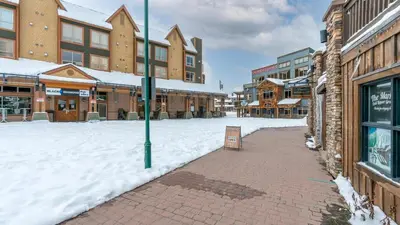 a snow covered street in a town with buildings at Raven's Nest - Mtn View & Hot Tub sleeps 6 in Carmi