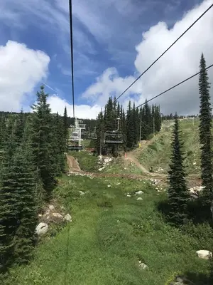 a gondola ride up a hill with trees at Raven's Nest - Mtn View & Hot Tub sleeps 6 in Carmi