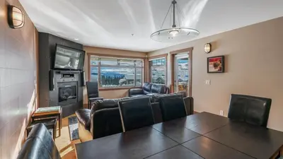 a living room with a table and leather chairs at Raven's Nest - Mtn View & Hot Tub sleeps 6 in Carmi