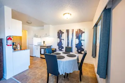 a kitchen and dining room with a table and chairs at Bearberry Premium Rentals in Whitehorse