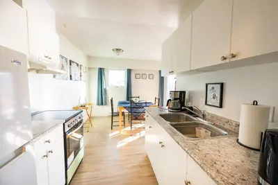 a kitchen with white cabinets and a counter top at Bearberry Premium Rentals in Whitehorse