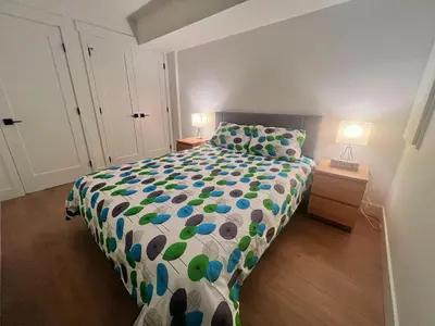 a bedroom with a bed with a blue and green comforter at Kris Anclam in Langley