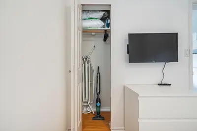 a living room with a tv on a white wall at Private Guest Suite with Kitchen in Vancouver