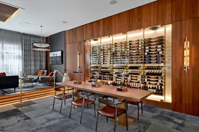 a dining room with a table and a wine cellar at Courtyard by Marriott Calgary South in Calgary
