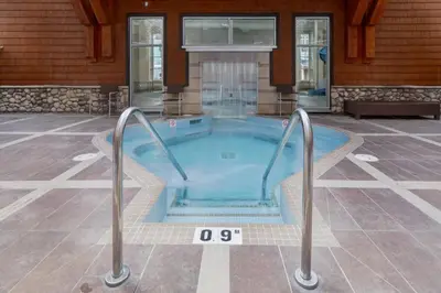a hot tub in the middle of a house at Amazing Views 1BR Condo with Hot Tub and Pool in Canmore