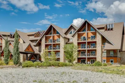 an exterior view of an apartment building at Amazing Views 1BR Condo with Hot Tub and Pool in Canmore