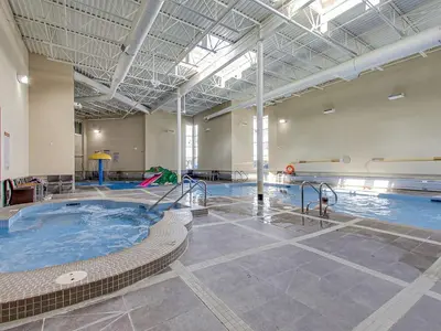 a large indoor swimming pool with a hot tub at Mountain View Penthouse 3BR with Private Hot Tub in Canmore