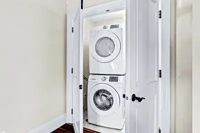 a laundry room with a washer and dryer at Mountain View Penthouse 3BR with Private Hot Tub in Canmore