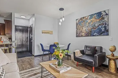 a living room with a couch and a table at Perfect Rockies Escape with Pool, Hot Tub and Gym in Canmore