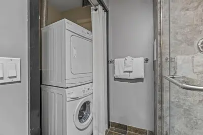 a white washer and dryer in a bathroom at Perfect Rockies Escape with Pool, Hot Tub and Gym in Canmore