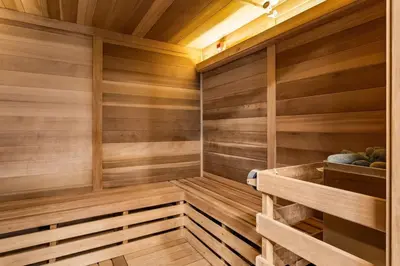 a sauna with wood paneling and a wooden ceiling at Brand New 1BR Canmore Retreat Hot Tub, Sauna, Gym in Canmore