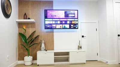 a living room with a tv on a wall at A true Home away from Home in Calgary
