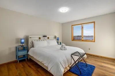 a bedroom with a bed with a teddy bear on it at Acreage, 3 King Beds and Ensuites, Dance Floor, Fireplace, AC in Calgary