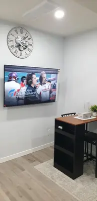 a picture of a hockey game on a wall at Executive 1Bedroom Suite By Henday in Edmonton