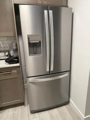 a stainless steel refrigerator in a kitchen at Cozy and modern two bedroom guest suite in Calgary