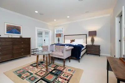 a bedroom with a bed and a table and a chair at Prime Richmond Stay 10 min to YVR & Steveston in Richmond