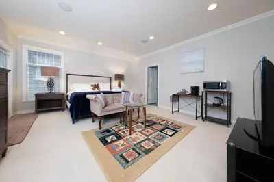 a bedroom with a bed and a desk and a table at Prime Richmond Stay 10 min to YVR & Steveston in Richmond