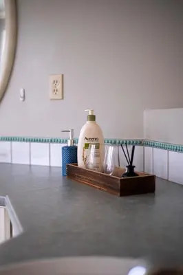 a counter top with a bottle of soap on a counter top at Prime Richmond Stay 10 min to YVR & Steveston in Richmond