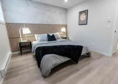 a bedroom with a large bed and two lamps at YYC Retreat - Near Mountains & Airport in Calgary