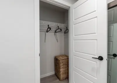 a bathroom with a white door and a closet at YYC Retreat - Near Mountains & Airport in Calgary