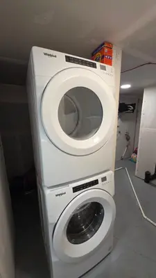 a washer and dryer sitting in a room at Modern 2BR Suite in Seton, Calgary in Calgary