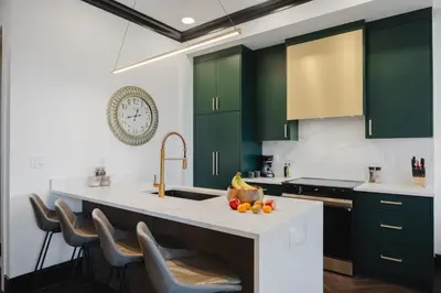 a kitchen with green cabinets and a counter with a sink at Walk University District, Near Hospitals & Shops in Calgary