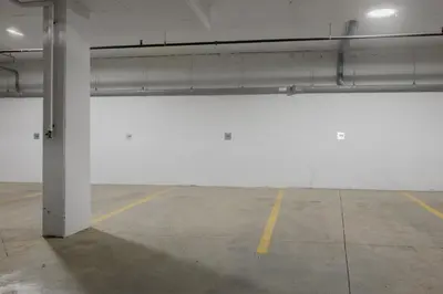 a large white wall in a parking lot at Walk University District, Near Hospitals & Shops in Calgary