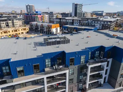 an overhead view of a blue building in a city at Walk University District, Near Hospitals & Shops in Calgary