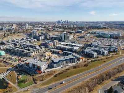 an aerial view of a city with buildings and a highway at Walk University District, Near Hospitals & Shops in Calgary