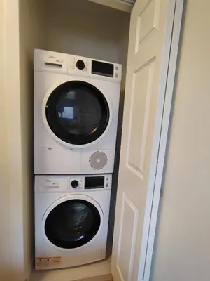 a washer and dryer in a room next to a door at Renovated North Vancouver Gem in North Vancouver