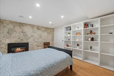 a bedroom with a bed and a fireplace at Renovated North Vancouver Gem in North Vancouver