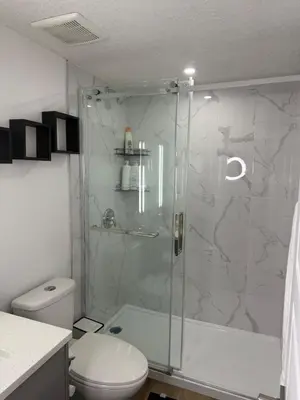 a bathroom with a shower and a toilet at Serenity Suite 3603 in Edmonton