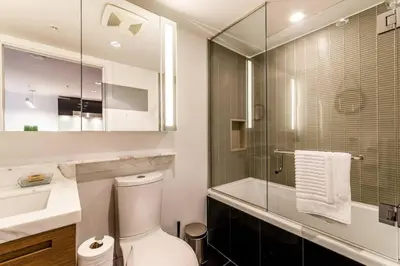 a bathroom with a toilet and a sink and a shower at Corporate Stays Telus Gardens 1 Bedroom in Vancouver