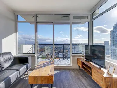 a living room with a couch and a television at Corporate Stays Hazel 1 Bedroom in Burnaby