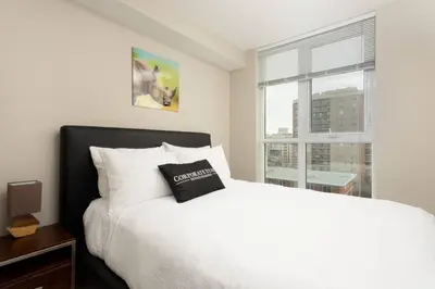 a bedroom with a white bed and a window at Corporate Stays Hendrix - 2 Bedrooms in Edmonton