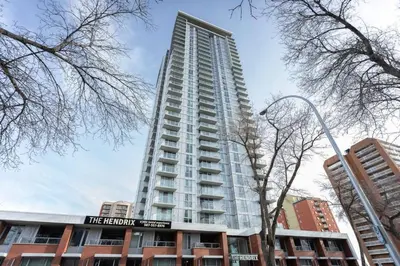 a tall building with a sign in front of it at Corporate Stays Hendrix - 2 Bedrooms in Edmonton