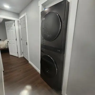a black washer and dryer in a room at beautiful private house in Edmonton
