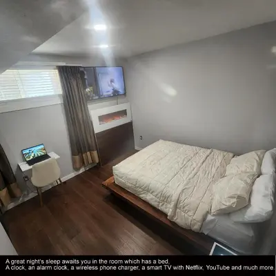 a bedroom with a bed and a desk and a tv at beautiful private house in Edmonton