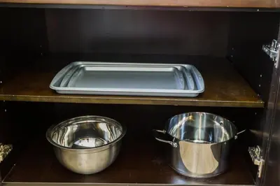 three metal pots and pans sitting on a counter at 5BDRM Bright Modern Home-King Bed-Garage-Sleeps 12 in Edmonton