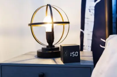 a lamp on a dresser with a clock on it at 5BDRM Bright Modern Home-King Bed-Garage-Sleeps 12 in Edmonton