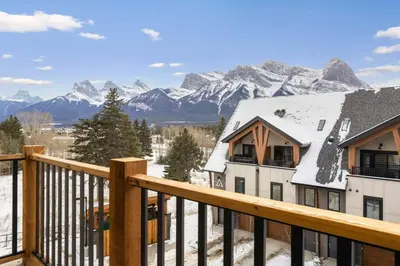a view of the mountains from the balcony of a house at 3BR Mountain Bliss Retreat with Gym Hot Tub and Sauna in Canmore