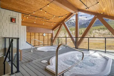 a hot tub in a room with a roof at 3BR Mountain Bliss Retreat with Gym Hot Tub and Sauna in Canmore