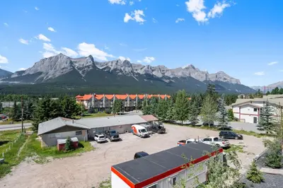 an aerial view of a parking lot with mountains in the background at Modern 4BR Mountain Retreat Balcony BBQ near DT in Canmore