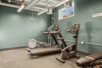 a gym with three exercise bikes in a room at Modern 4BR Mountain Retreat Balcony BBQ near DT in Canmore