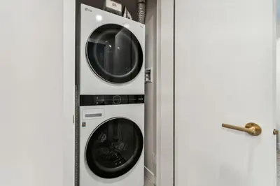 a washing machine and a dryer in a room at 4BR Golden Ridge Mountain Escape with Hot Tub and Gym in Canmore