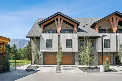 a large house with a garage at 4BR Golden Ridge Mountain Escape with Hot Tub and Gym in Canmore