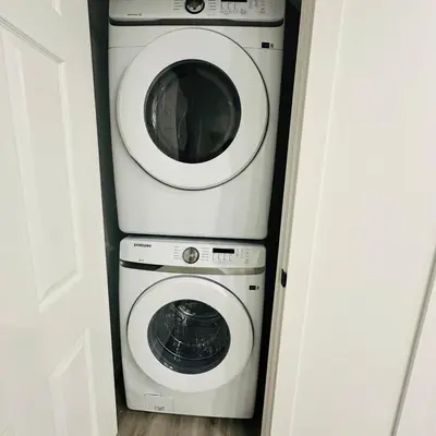a washing machine and a dryer in a room at Modern Basement Suite near West Edmonton Mall in Edmonton